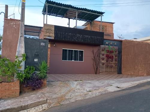 a house with a gate and a fence at Pousada Casa Jardim in Serra Negra