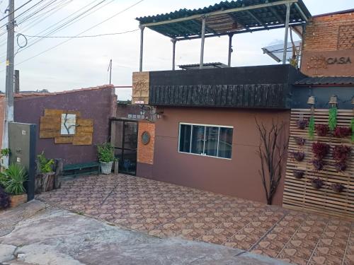 a house with a brick driveway in front of it at Pousada Casa Jardim in Serra Negra