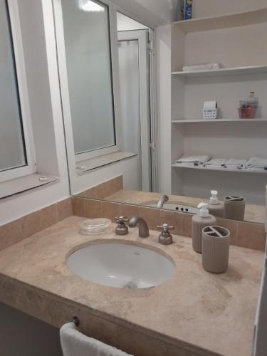 a bathroom counter with a sink and a mirror at Duplex en salta in Destilería Chachapoyas