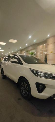 a white car is parked in a garage at Lajeka Rental Mobil Makassar in Makassar