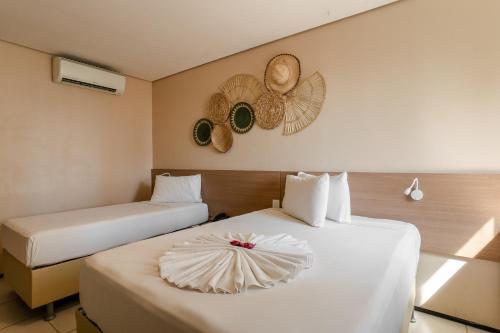 two beds in a hotel room with two beds at Fortaleza Mar Hotel in Fortaleza