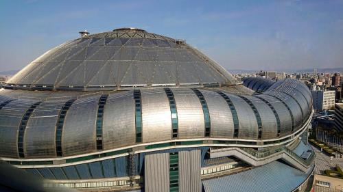 a large building with a dome on top of it at Hotel Public Jam in Osaka