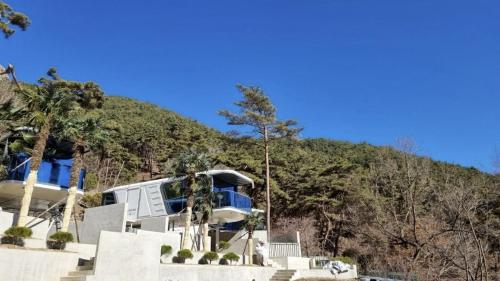 a rv parked in front of a mountain at Damyang Lisa Forest Village in Damyang