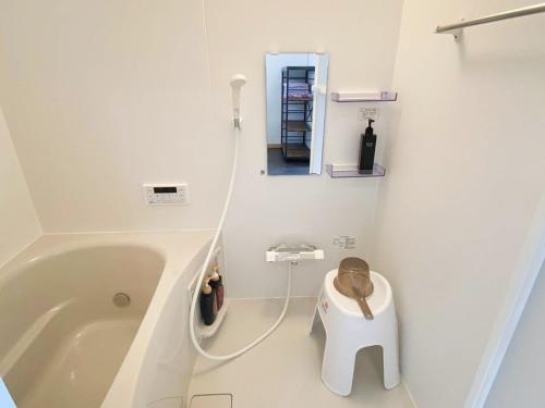 a bathroom with a tub with a toilet in it at しまなみ海道 COTTAGE Umimae in Onomichi