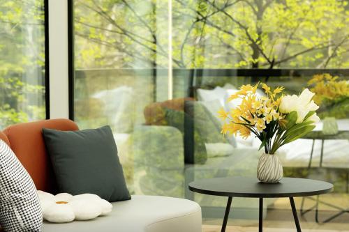 a living room with a vase of flowers on a table at Damyang Lisa Forest Village in Damyang