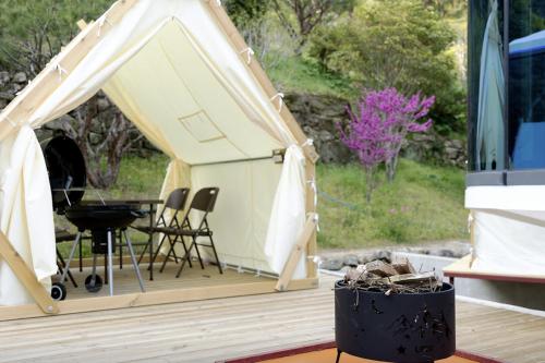a gazebo with a table and chairs on a deck at Damyang Lisa Forest Village in Damyang