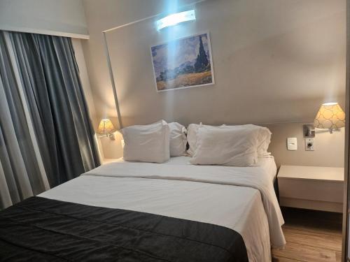 Ένα ή περισσότερα κρεβάτια σε δωμάτιο στο Hotel & Residência Alphaville