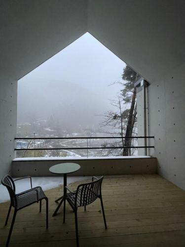 a room with two chairs and a table and a window at Damyang Lisa Forest Village in Damyang