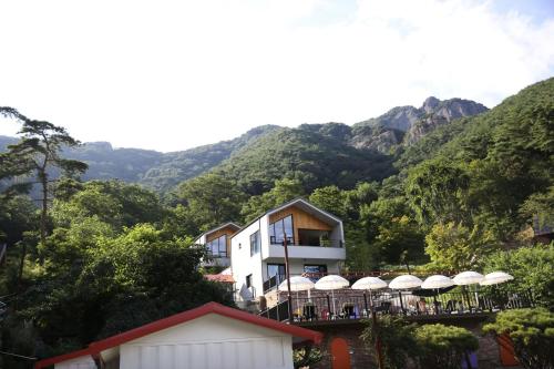 a view of a building with mountains in the background at Damyang Lisa Forest Village in Damyang