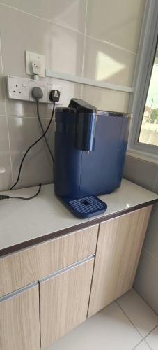 a large blue bucket sitting on top of a counter at Sakura homestay 5 bedrooms - Spring Lopeng 14 pax in Miri