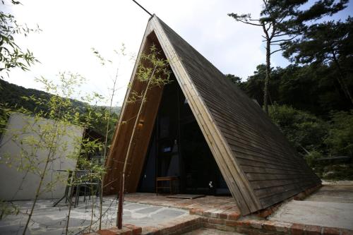 a triangular house with a triangular roof at Damyang Lisa Forest Village in Damyang