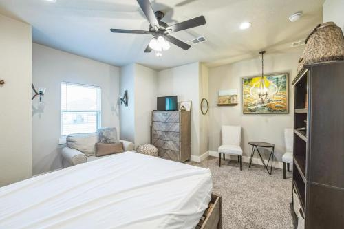 a bedroom with a bed and a ceiling fan at New Stunning and Vibrant Kitchen-Smart TVs-Modern Gas Firepit-Free Parking in Granbury
