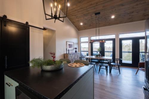 a kitchen and living room with a table and chairs at A Red River Barnhouse in Rogers