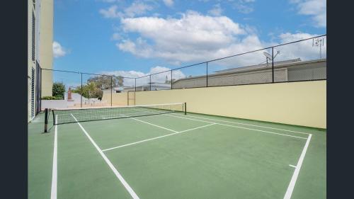 a tennis court with a net on top of it at Sea Breeze At Mudjimba Beachside, Tennis Pool in Mudjimba