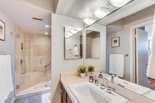 a white bathroom with a sink and a shower at Mtn-View Condo with Pool Access in Palm Springs! in Palm Springs