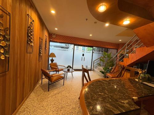 a living room with a table and chairs and a staircase at Ciello Accomodation in Cagayan de Oro