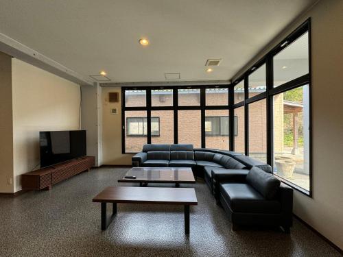 a living room with a couch and a tv at 波のたわむれ in Kami Amakusa