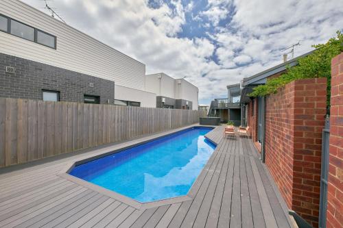a swimming pool in the backyard of a house at The Palm House 200 meters to the beach in Torquay
