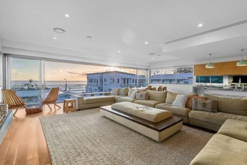 a large living room with a couch and a table at Daybreak at Currumbin in Gold Coast