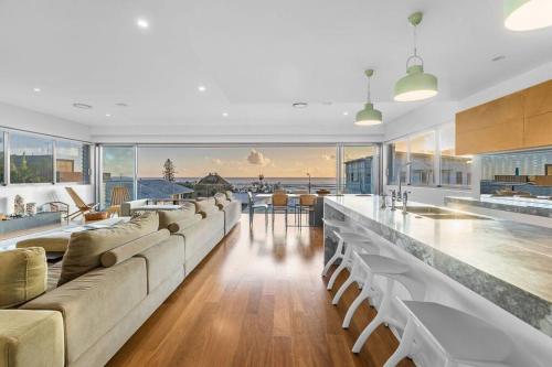 a large living room with couches and a bar at Daybreak at Currumbin in Gold Coast