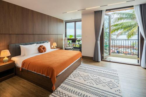 a hotel room with a bed and a large window at Mai Villa Hoi An - 3 steps to Night Market in Hoi An