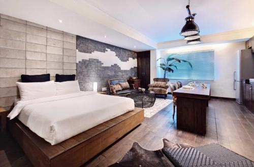 a bedroom with a large bed and a living room at Seoul Loft Apartments - SLA 7 Night Minimum in Seoul