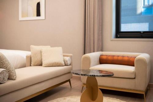 a living room with a couch and a coffee table at Hound Hotel Yeonsan in Busan
