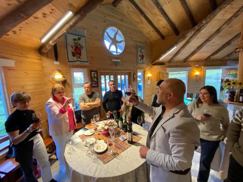 a group of people standing around a table with wine glasses at Cabañas Sol de Aucar in Quemchi