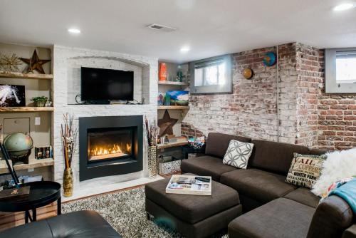a living room with a couch and a fireplace at Designer Apartment in a Historic 1901 Downtown Area Mansion in Denver
