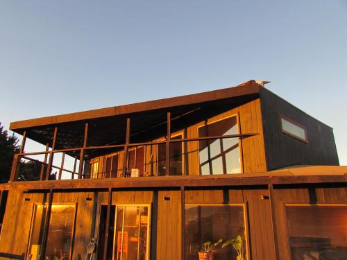 a large wooden house with a lot of windows at La madriguera Matanzas in Navidad