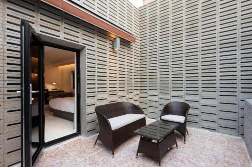 a bedroom with a bed and a chair and a table at Hound Hotel Yeonsan in Busan