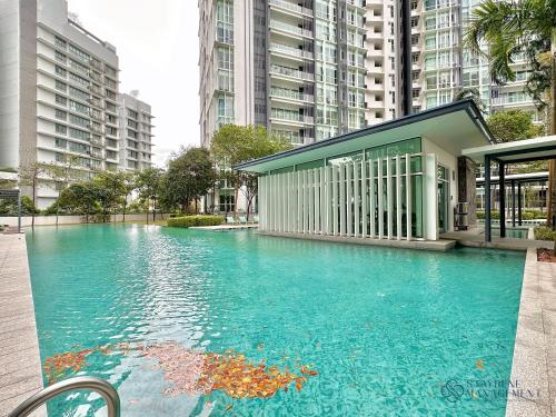a large pool of blue water with tall buildings at Medini Signature Near Legoland By Stayrene in Iskandar Puteri