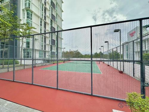 a tennis court in a building with a fence at Medini Signature Near Legoland By Stayrene in Iskandar Puteri