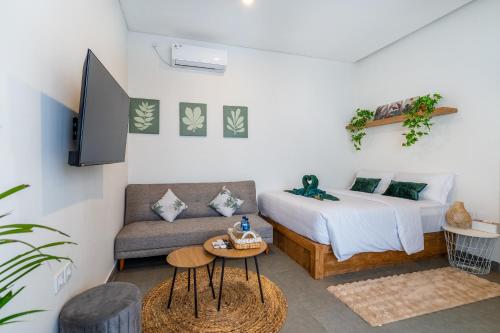 a living room with a bed and a couch at Standart Room in Sanur
