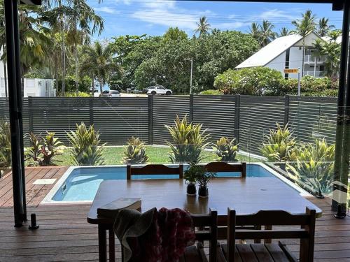 a table and chairs next to a swimming pool at Harper in Mission Beach
