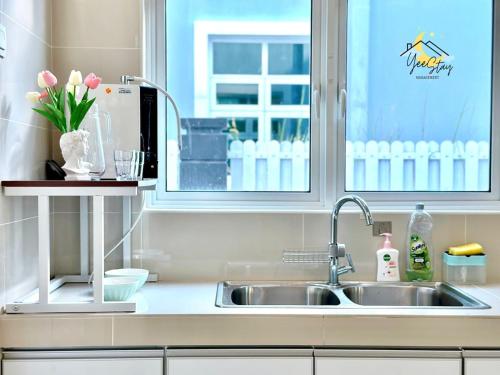 a kitchen counter with a sink and a window at Bungalow Villa 21pax Game Machine Pool table Ktv in Melaka