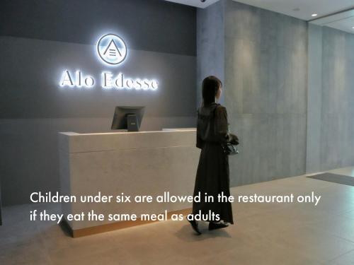 a woman standing in front of a sign in a store at asbo stay hotel in Kin