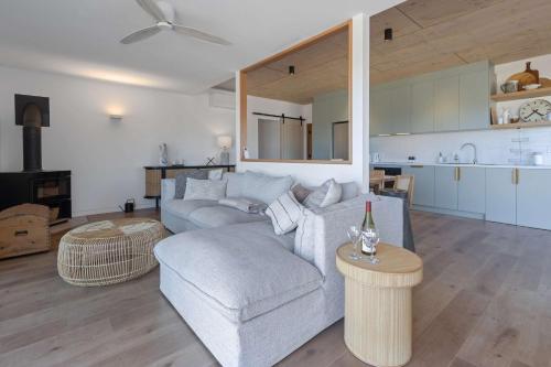 a living room with a couch and a table at Luxe Scandinavian 2BR Retreat Near McLaren Vale in Clarendon