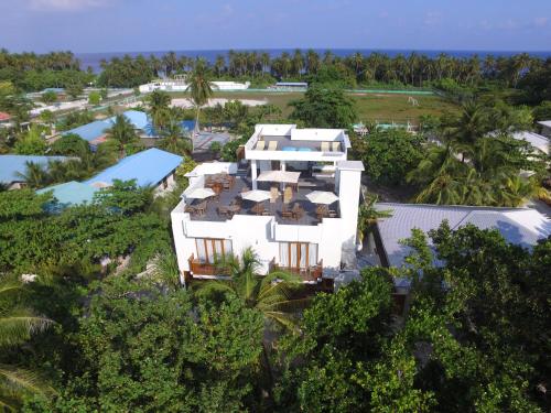 an aerial view of a resort with a pool at Boutique Beach All Inclusive Diving Hotel in Dhigurah