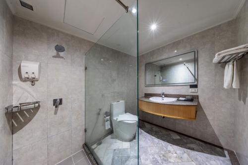 a bathroom with a toilet and a sink at The Maruay Garden Hotel in Bangkok