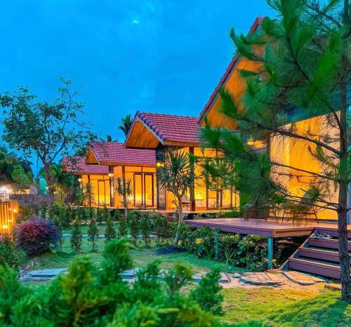 a house in the middle of a garden at The Lake Farm - Dak Lak in Buon Ma Thuot