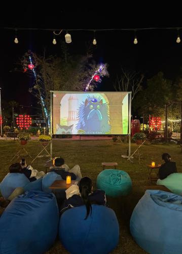 a group of people sitting on bean bags watching a screen at The Lake Farm - Dak Lak in Buon Ma Thuot