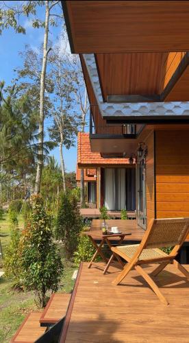 a porch of a house with a table and chairs at The Lake Farm - Dak Lak in Buon Ma Thuot