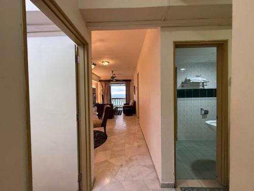 a hallway of a house with a bathroom and a sink at 3 BEDROOM SEAVIEW CONDO @ GLORY BEACH RESORT, PORT DICKSON in Port Dickson