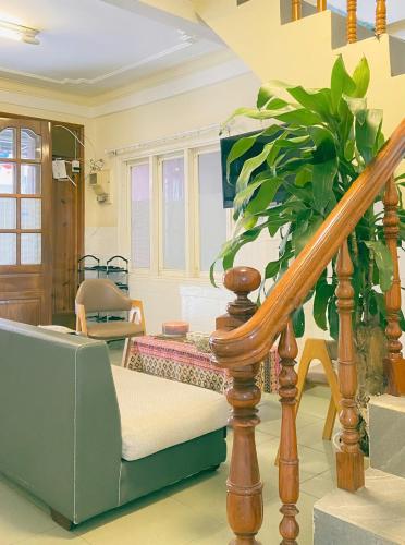 a living room with a staircase and a plant at Chất home in Da Lat
