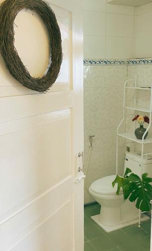 a bathroom with a white toilet and a plant at Chất home in Da Lat