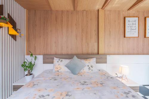 a bedroom with a large bed with wooden walls at La Cle' Đà Lạt in Da Lat
