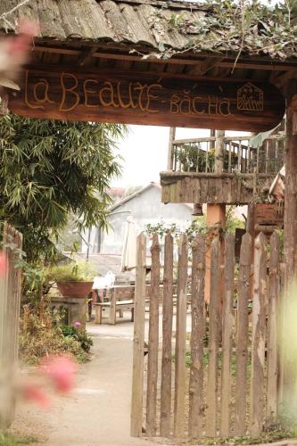 a wooden fence with a sign that reads beware bacteria at La Beauté Bắc Hà in Bắc Hà