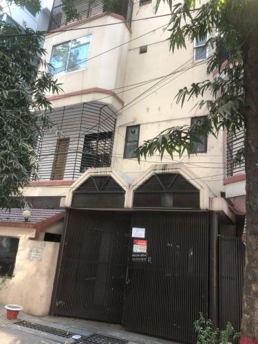 a building with a gate in front of it at Maya Eco Guest House in Dhaka