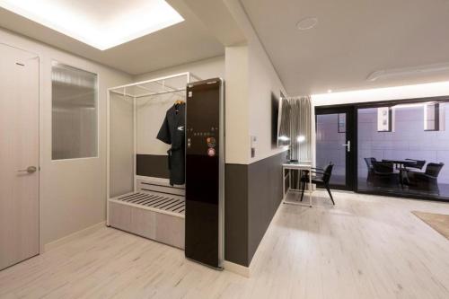 a room with a kitchen and a dining room at Hound Hotel Yeonsan in Busan